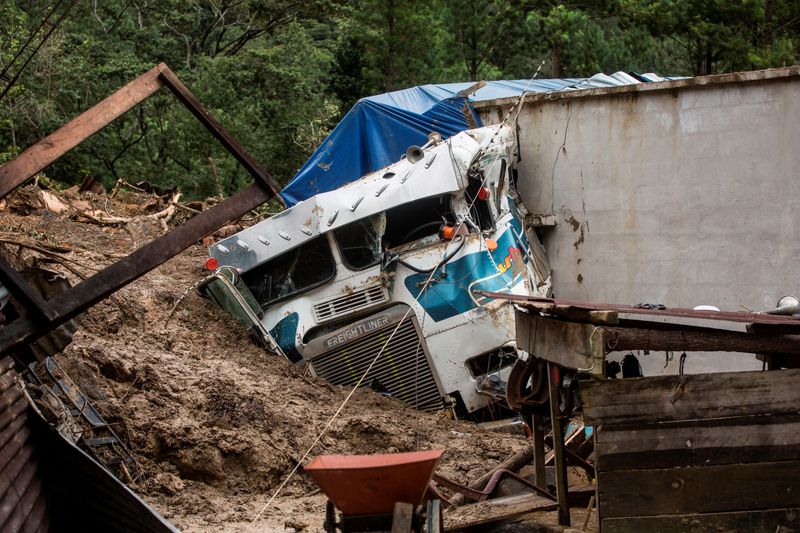 &copy; Reuters. The wreckage of a trailer is seen at an area hit by a mudslide, caused by heavy rains brought by Storm Eta, as the search for victims continue in the buried village of Queja