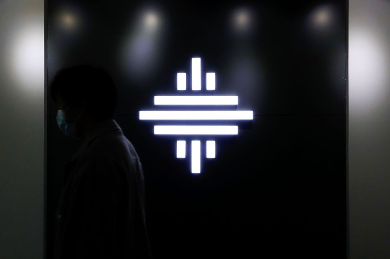 &copy; Reuters. A man wearing a face mask walks past a logo of autonomous truck startup Inceptio Technology at its office in Beijing