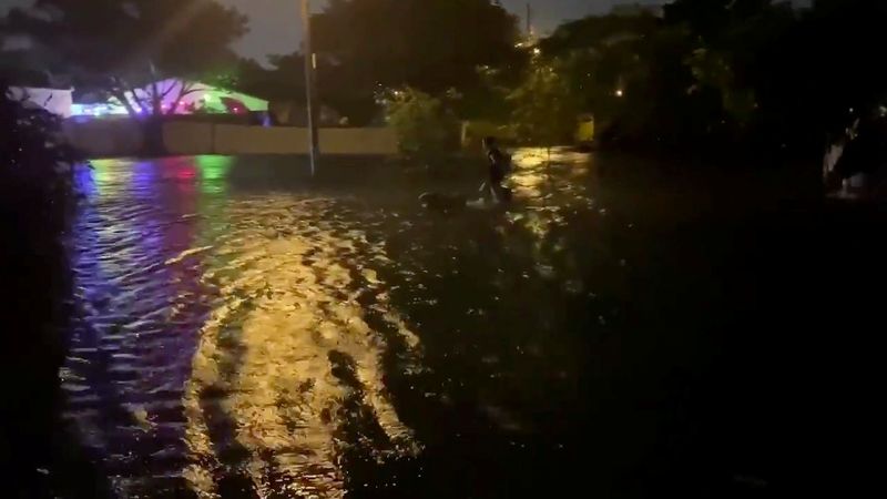 &copy; Reuters. People walk in floodwaters caused by Storm Eta in Fort Lauderdale, Florida, U.S. in this still frame picture obtained from social media video dated November 8, 2020