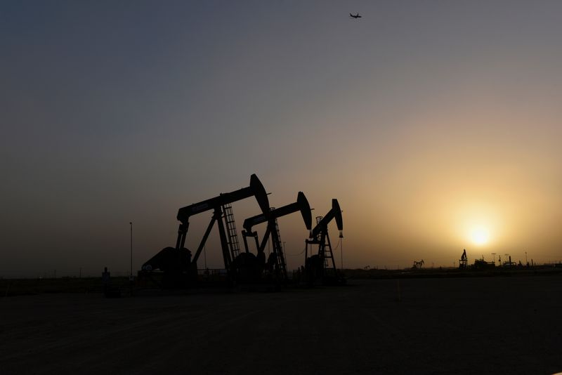 &copy; Reuters. Pump jacks operate at sunset in Midland