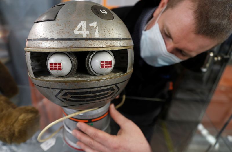 &copy; Reuters. Alastair McCrea of Ewbank&apos;s Auctioneers, positions a Zeroid model from Gerry Anderson and Christopher Burr&apos;s Terrahawks at their showroom, ahead of a sale in Woking