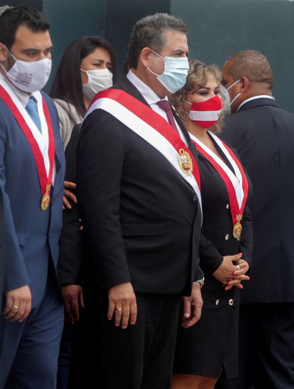 © Reuters. Peru's interim President Manuel Merino (C) leaves Congress after he was sworn in following the removal of President Martin Vizcarra by lawmakers, in Lima