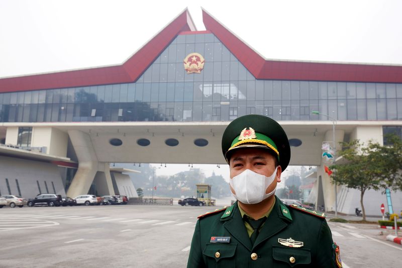 © Reuters. FILE PHOTO: A Vietnamese border guard officer wearing protective mask stands guard at Huu Nghi border gate connecting with China, in Lang Son province, Vietnam