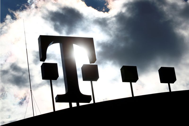 &copy; Reuters. FILE PHOTO: Logo of Deutsche Telekom AG is silhouetted atop of the headquarters of the German telecommunications giant in Bonn