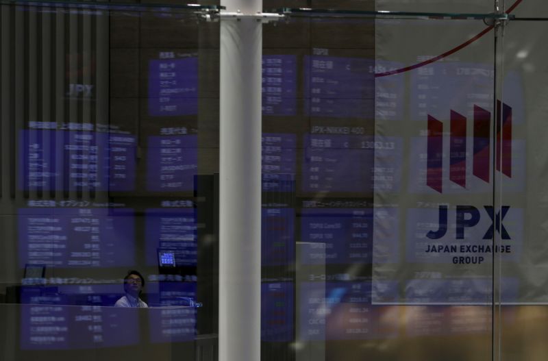 &copy; Reuters. A man looks at an electronic board showing Japan&apos;s Nikkei average and related indices at the Tokyo Stock Exchange in Tokyo