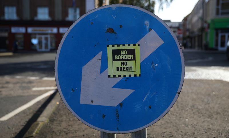 © Reuters. A 'No hard Border' poster is seen below a road sign on the Irish side of the border between Ireland and Northern Ireland near Bridgend Ireland