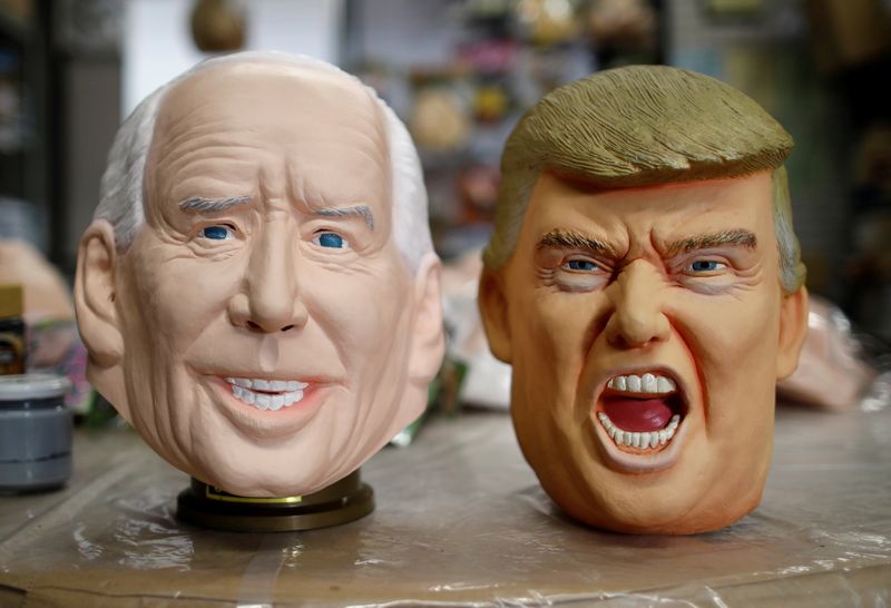 © Reuters. Masks depicting U.S. President-elect Joe Biden and President Donald Trump are displayed at Ogawa Studios, a mask and toy making company, in Saitama