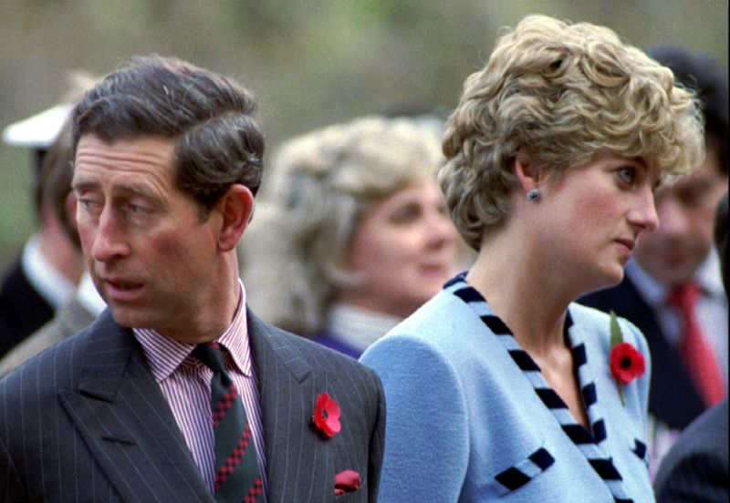&copy; Reuters. FILE PHOTO: Princess Diana and Prince Charles look in different directions, November 3, during a service held to..