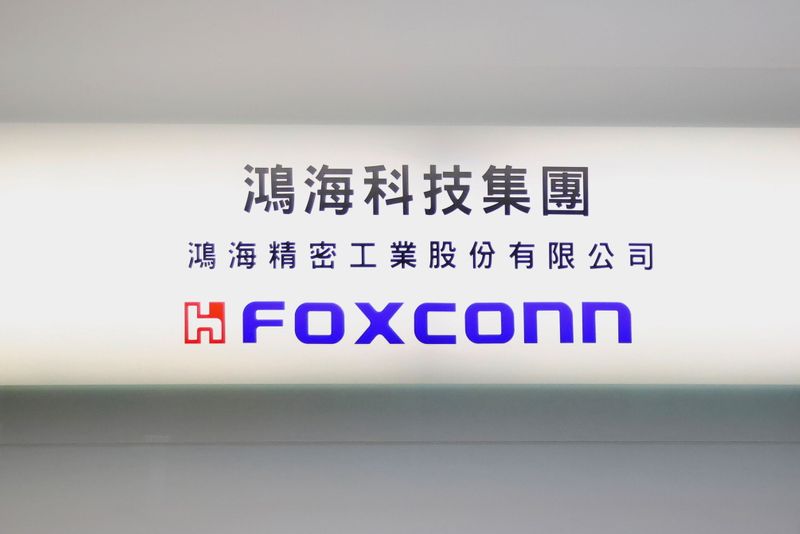 © Reuters. Sign of Foxconn is seen at a glass door inside its office building in Taipei