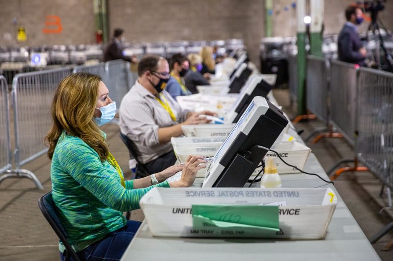 &copy; Reuters. Poll workers tabulate ballots at the Allegheny County Election Warehouse in Pittsburgh