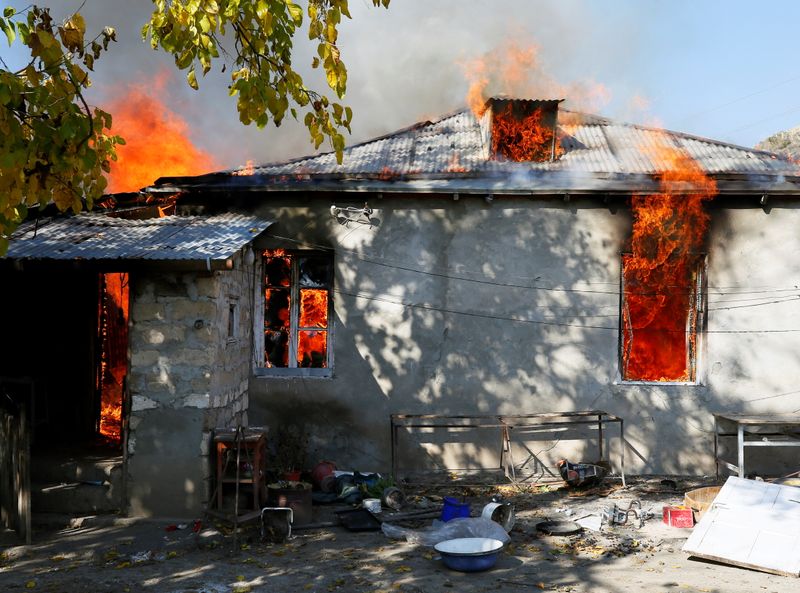 &copy; Reuters. A house is seen set on fire by departing Ethnic Armenians in the village of Cherektar, in the region of Nagorno-Karabakh