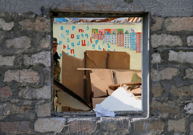 &copy; Reuters. An ethnic Armenian soldier is seen inside a destroyed school in the village of Knaravan