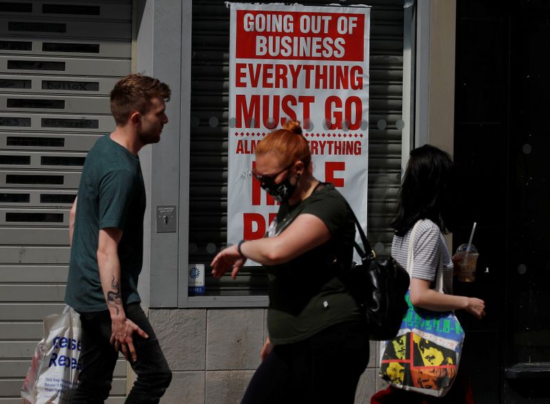 &copy; Reuters. People walk past a closed shop following the outbreak of the coronavirus disease (COVID-19) in Chester, Britain