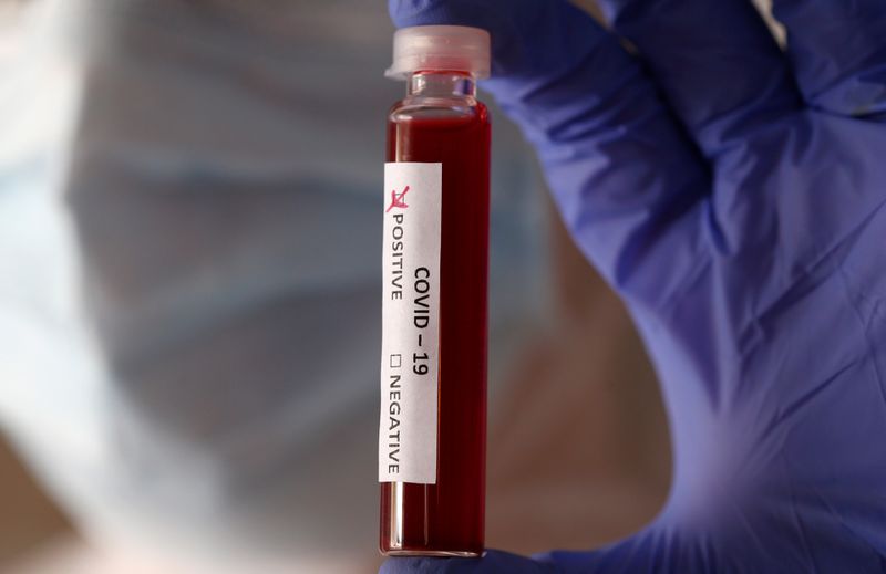 &copy; Reuters. Fake blood is seen in test tubes labelled with the coronavirus (COVID-19) in this illustration