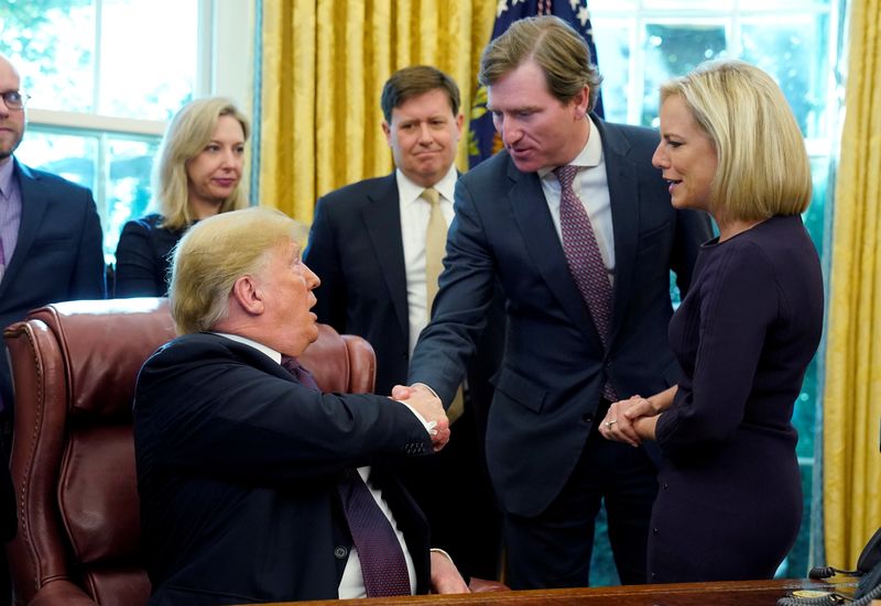 © Reuters. FILE PHOTO: U.S. President Trump shakes hands with Krebs at Cybersecurity and Infrastructure signing ceremony in Oval Office of White House in Washington