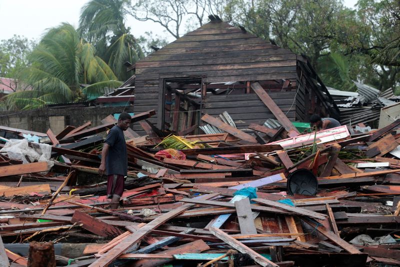 &copy; Reuters. Residents remove debris from their destroyed houses after the passing of Hurricane Iota, in Puerto Cabezas