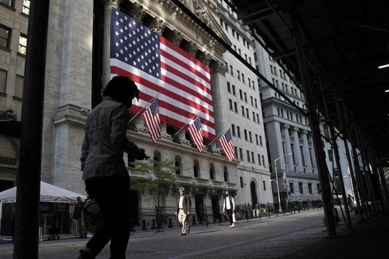 &copy; Reuters. A person walks past the New York Stock Exchange