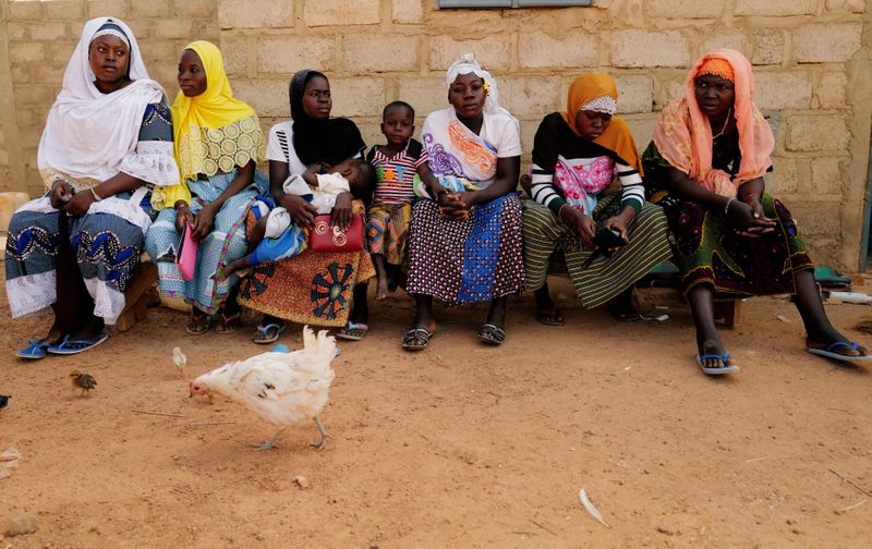 &copy; Reuters. Women who fled from attacks of armed militants in Sahel region of Soum sit at a courtyard of the house in an informal camp for displaced people on the outskirts of Ouagadougou,