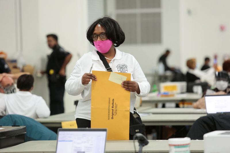 &copy; Reuters. A poll worker supervisor handles an envelope of original ballots at the TCF center after Election Day in Detroit, Michigan