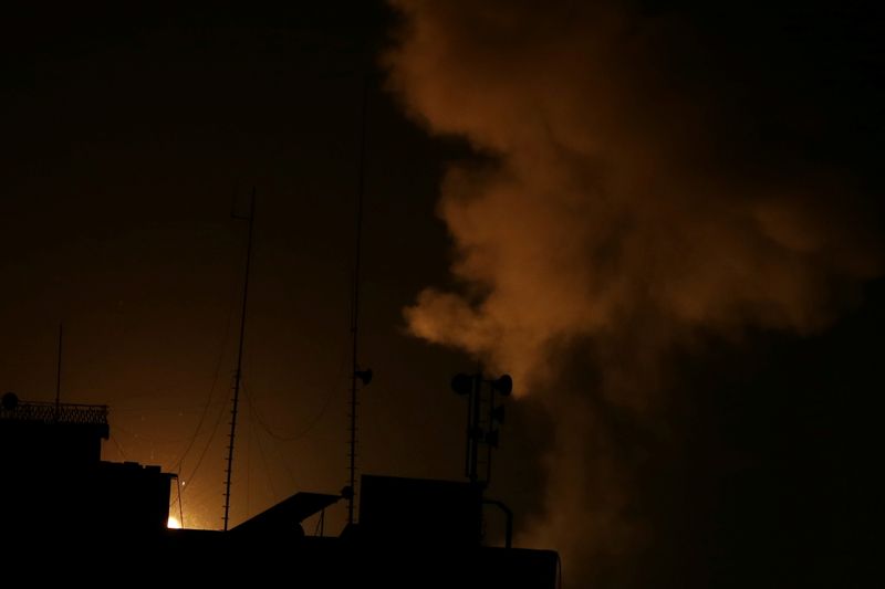 © Reuters. Smoke and flame are seen following an Israeli air strike in Gaza Strip