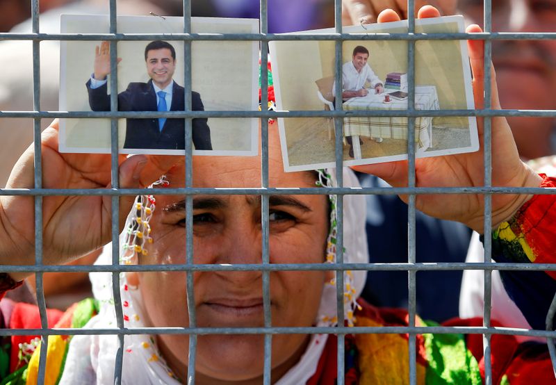 &copy; Reuters. FILE PHOTO: A woman holds pictures of jailed former leader of Turkey&apos;s main pro-Kurdish Peoples&apos; Democratic Party Selahattin Demirtas as people gather to celebrate Newroz, which marks the arrival of spring and the new year, in Istanbul