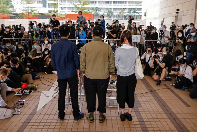 © Reuters. Pro-democracy activists Ivan Lam, Joshua Wong and Agnes Chow arrive at the West Kowloon Magistrates' Courts to face charges related to illegal assembly stemming from 2019, in Hong Kong