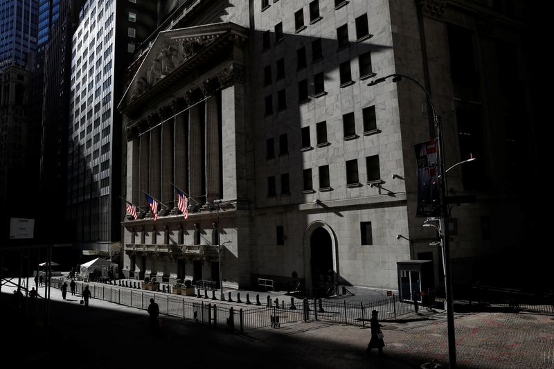 &copy; Reuters. FILE PHOTO: The New York Stock Exchange (NYSE) is seen as people walk in silhouette in the financial district of New York