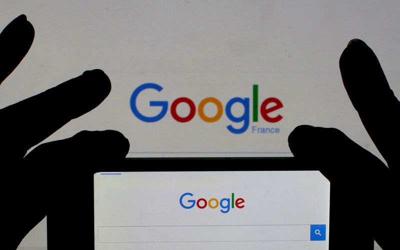 &copy; Reuters. FILE PHOTO: File photo of a woman holding her smart phone which displays the Google home page, in this picture illustration