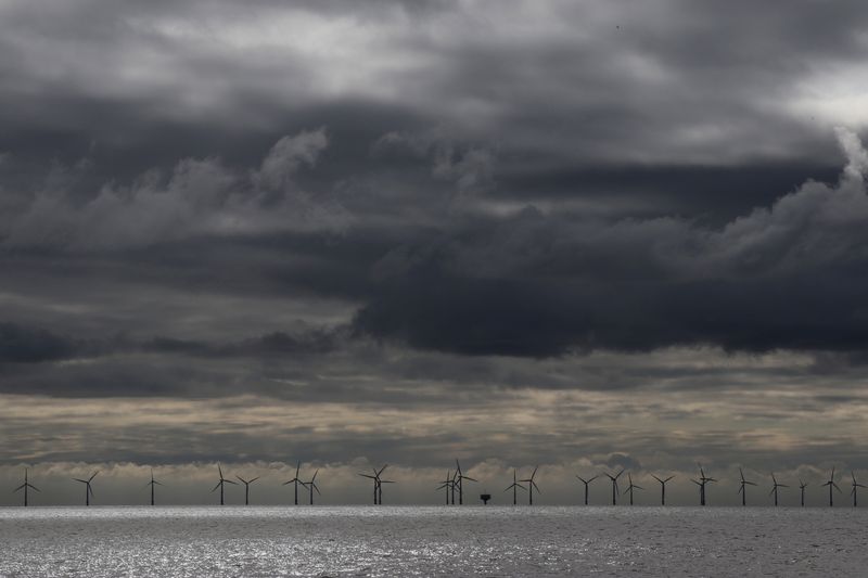 &copy; Reuters. Rain clouds gather over an offshore windfarm off the coast of Finton-on Sea, Britain