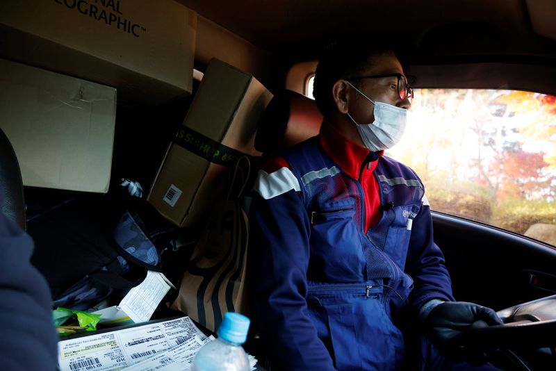 © Reuters. Jeong, a parcel delivery worker for CJ Logistics, drives his truck in Gwangju