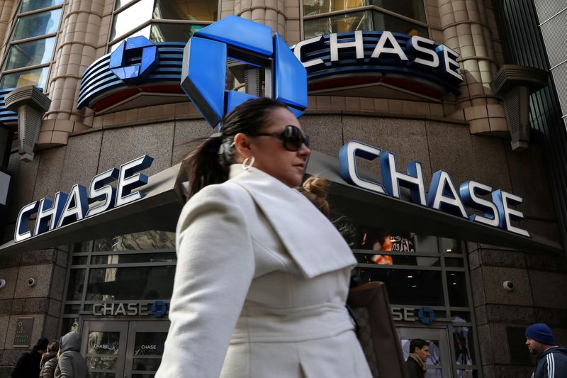 &copy; Reuters. FILE PHOTO: A woman passes by a JPMorgan Chase bank in Times Square in New York