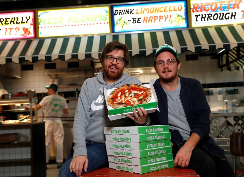 &copy; Reuters. Co-founders of Pizza Pilgrims, brothers Thom (L) and James Elliot, pose for a photograph in one of their restaurants amid the coronavirus disease (COVID-19) outbreak in London