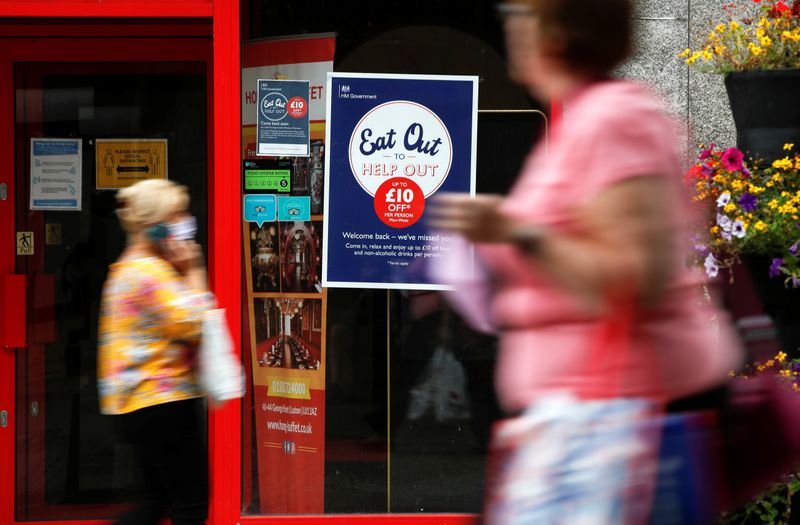 © Reuters. People walk past a take-out restaurant with an 