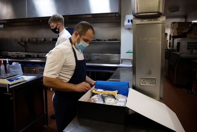 © Reuters. James Knappett, founder and head chef of 'Home' packs food into a box destined for customers in London