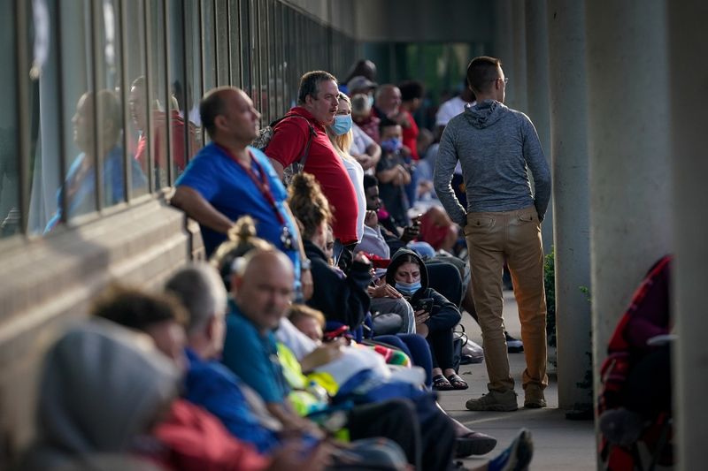 © Reuters. FILE PHOTO: People wait outside Kentucky Career Center in Frankfort