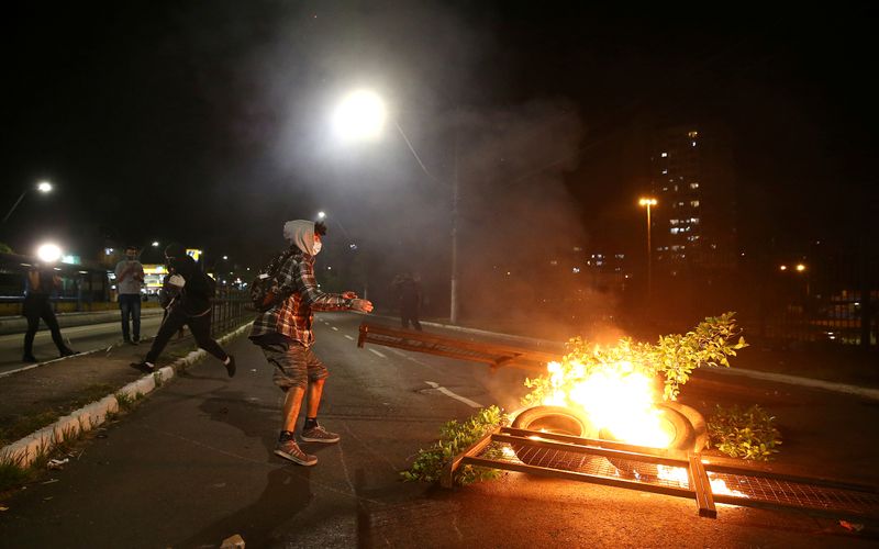 &copy; Reuters. FILE PHOTO: Demonstrator burns objects to block a street during a protest against racism, after Joao Alberto Silveira Freitas was beaten to death by security guards at a Carrefour supermarket in Porto Alegre