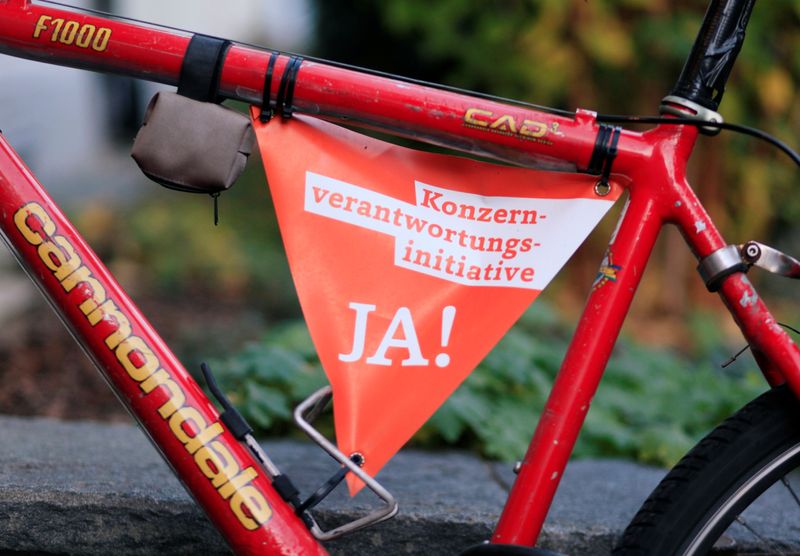 &copy; Reuters. A small banner reading: &quot;Responsible Business Initiative - Yes on November 29&quot; is fixed to the frame of a bicycle in Zurich