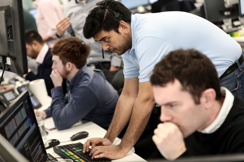 &copy; Reuters. Traders looks at financial information on computer screens on the IG Index trading floor