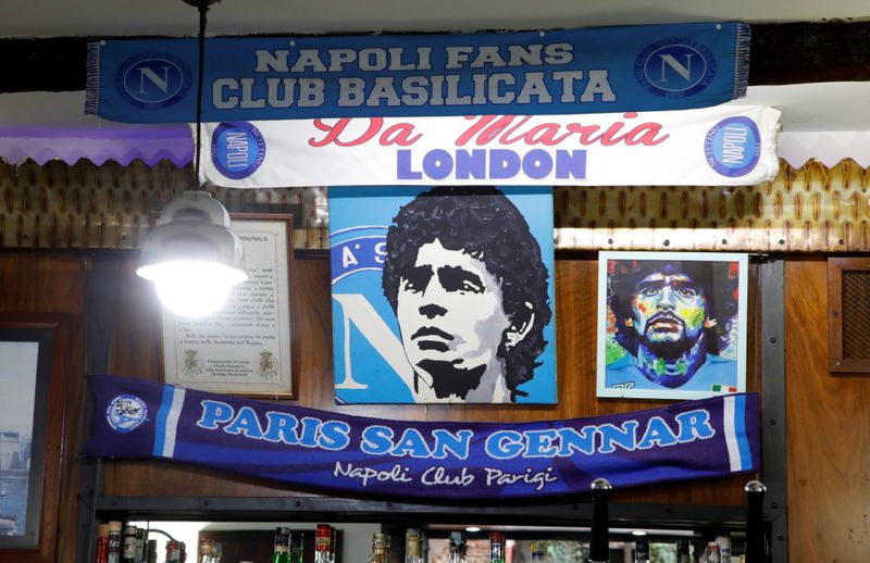 &copy; Reuters. Posters depicting late soccer legend Diego Maradona are pictured the day after his death in Naples