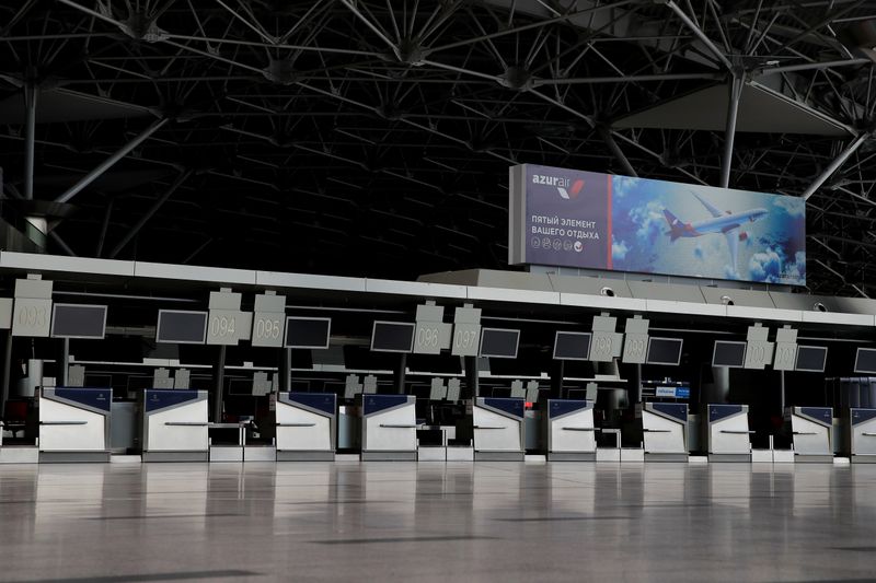 &copy; Reuters. Deserted check-in stands and an advertisement of Azur Air airlines are seen at Vnukovo International Airport amid the outbreak of the coronavirus disease (COVID-19) in Moscow