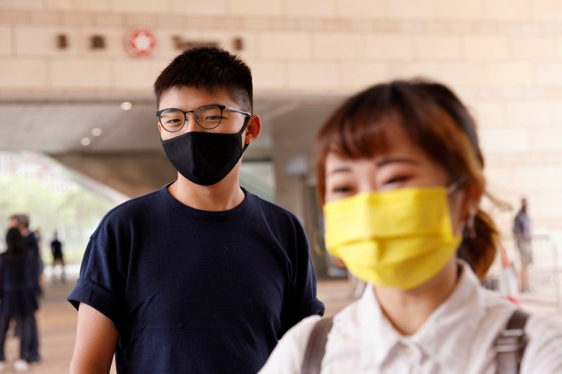 &copy; Reuters. FILE PHOTO: Pro-democracy activists Joshua Wong  and Tiffany Yuen arrive at West Kowloon Magistrates&apos;s Courts to face charges related to an illegal vigil assembly commemorating the 1989 Tiananmen Square crackdown, in Hong Kong