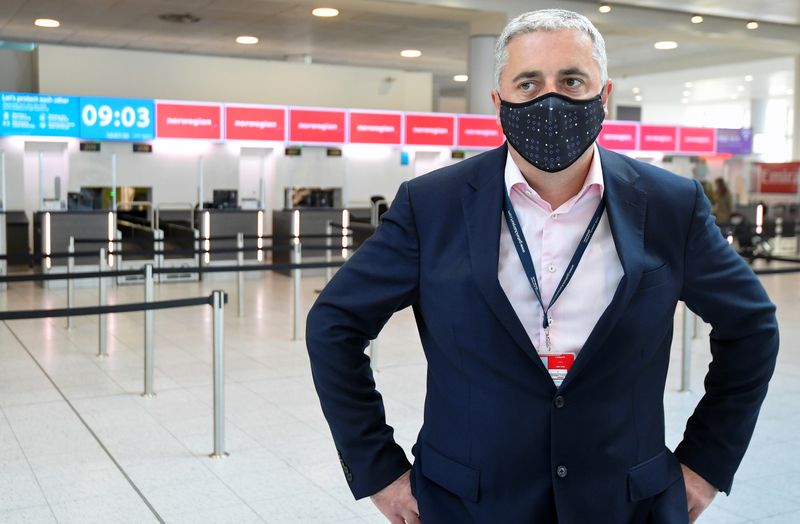 &copy; Reuters. FILE PHOTO: Stewart Wingate, a CEO of the Gatwick Airport, wearing a protective mask reacts during an interview with Reuters, at the Gatwick Airport, in Gatwick