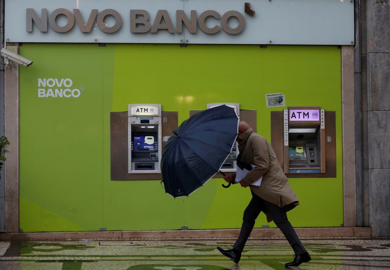 &copy; Reuters. FILE PHOTO: A man walks near ATM machines of a Novo Banco branch in downtown Lisbon, Portugal