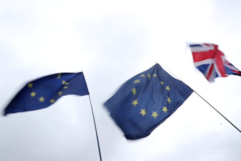 &copy; Reuters. A Union Jack flag flutters next to EU flags outside the Houses of Parliament in London