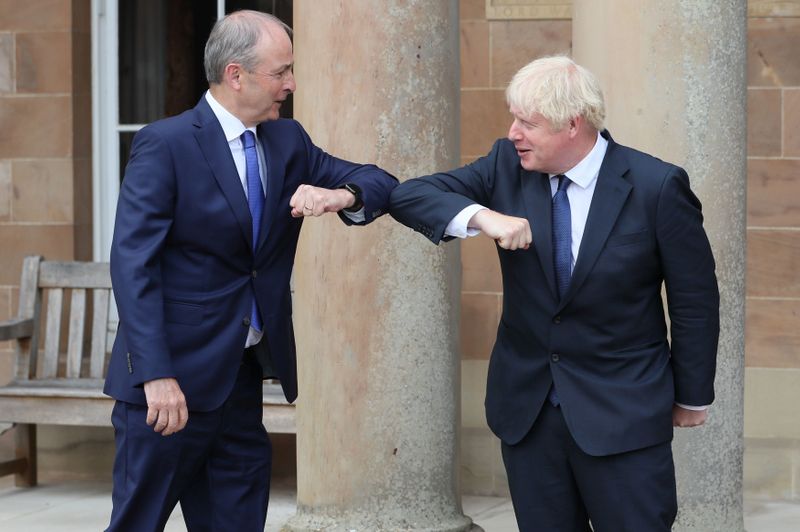 &copy; Reuters. Britain&apos;s Prime Minister Boris Johnson and Ireland&apos;s Prime Minister (Taoiseach) Micheal Martin greet each other with an elbow bump at Hillsborough Castle, in Belfast