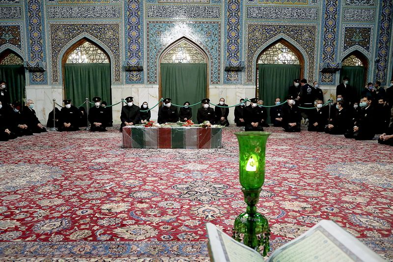 &copy; Reuters. Servants of the holy shrine of Imam Reza sit near the coffin of Iranian nuclear scientist Mohsen Fakhrizadeh, in Mashhad