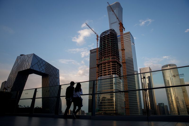 &copy; Reuters. FILE PHOTO: People look at the skyline of the Central Business District in Beijing