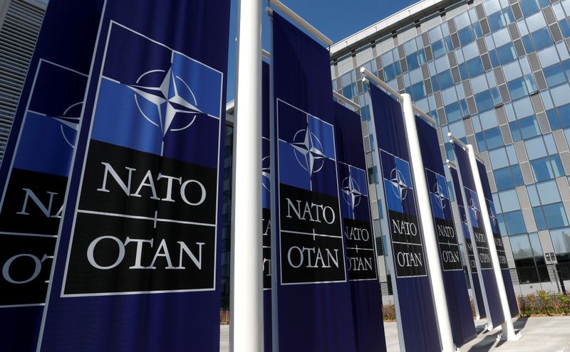 © Reuters. FILE PHOTO: Banners displaying the NATO logo are placed at the entrance of new NATO headquarters during the move to the new building