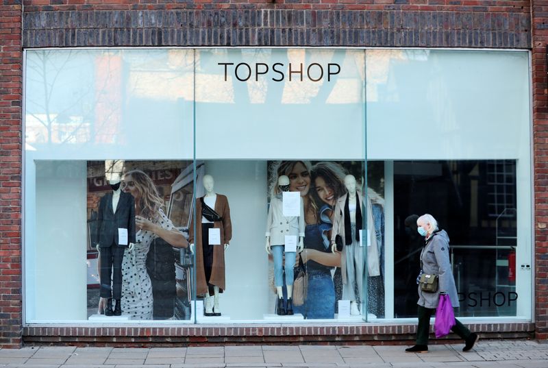 &copy; Reuters. FILE PHOTO: A woman walks past a TopShop, as the spread of the coronavirus disease (COVID-19) continues, in York