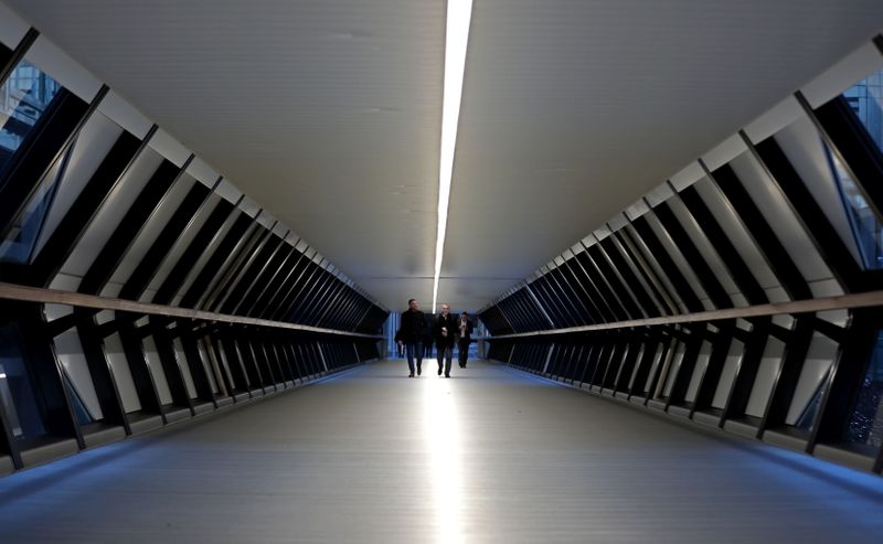 &copy; Reuters. FILE PHOTO: People walk through the Crossrail Place Bridge in the Canary Wharf financial district of London